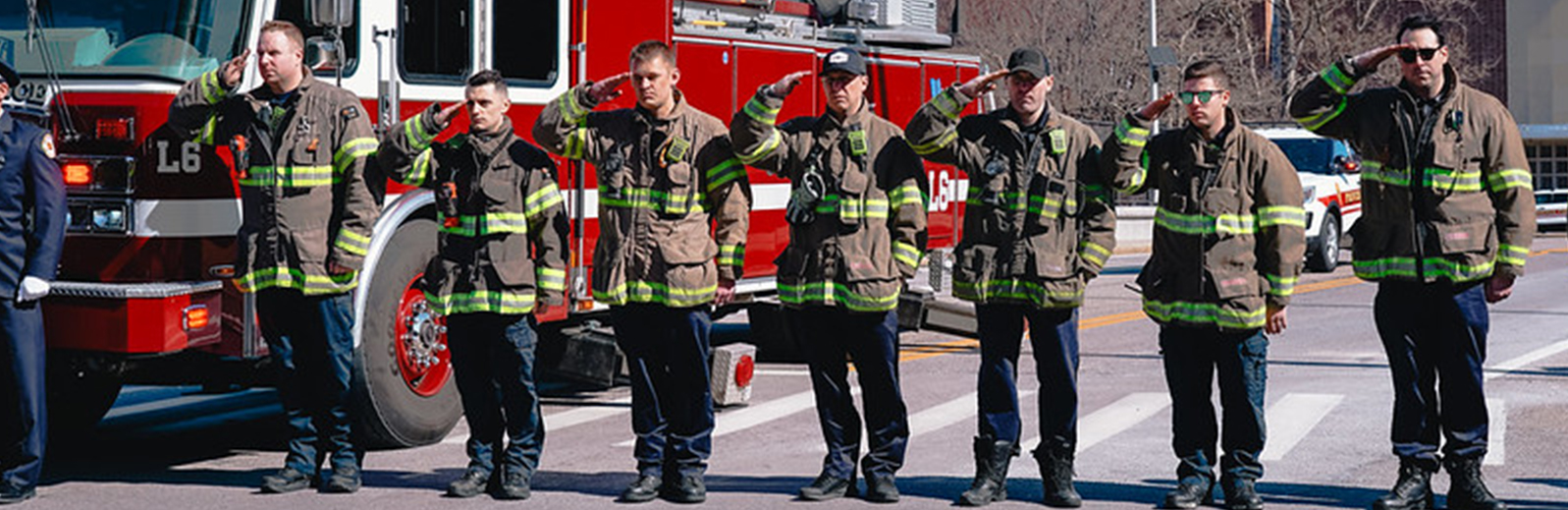 fire fighters standing in front of a truck